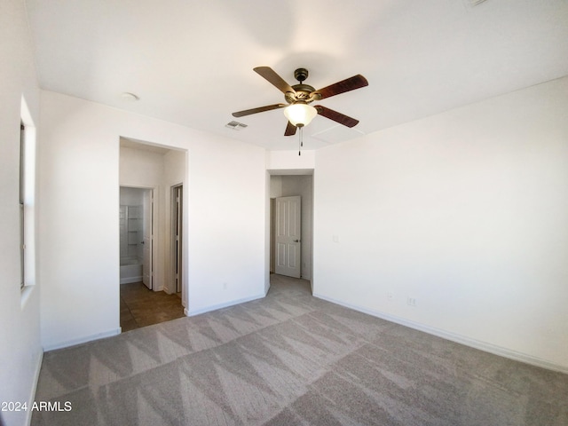 carpeted spare room with ceiling fan