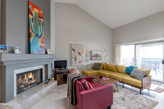 living room with high vaulted ceiling and light tile patterned floors