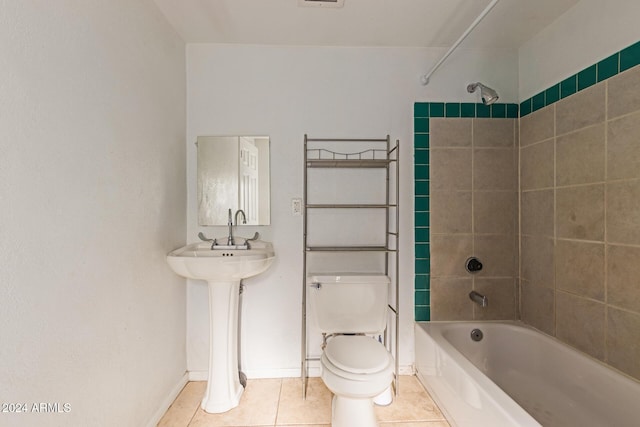 bathroom with toilet, tiled shower / bath combo, and tile patterned floors