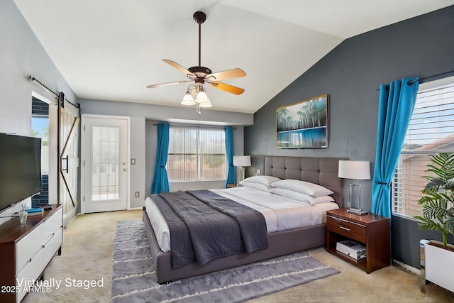 bedroom with a barn door, a ceiling fan, access to exterior, carpet flooring, and lofted ceiling