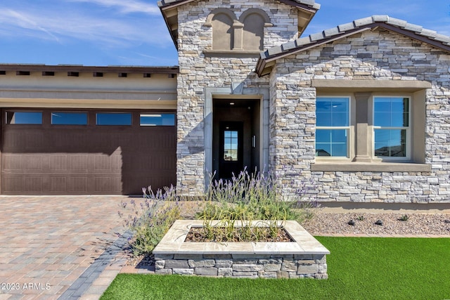 exterior space with stone siding and decorative driveway