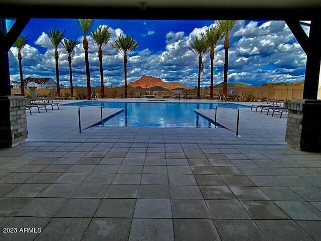 pool with a patio and fence