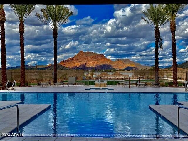 pool featuring fence and a mountain view