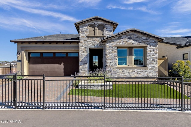 view of front facade featuring driveway, a garage, stone siding, and a fenced front yard