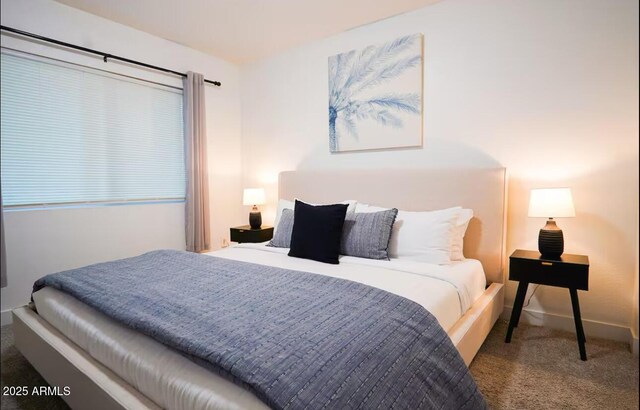 carpeted bedroom featuring baseboards
