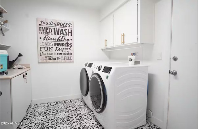 laundry area featuring washer and dryer, cabinet space, and baseboards