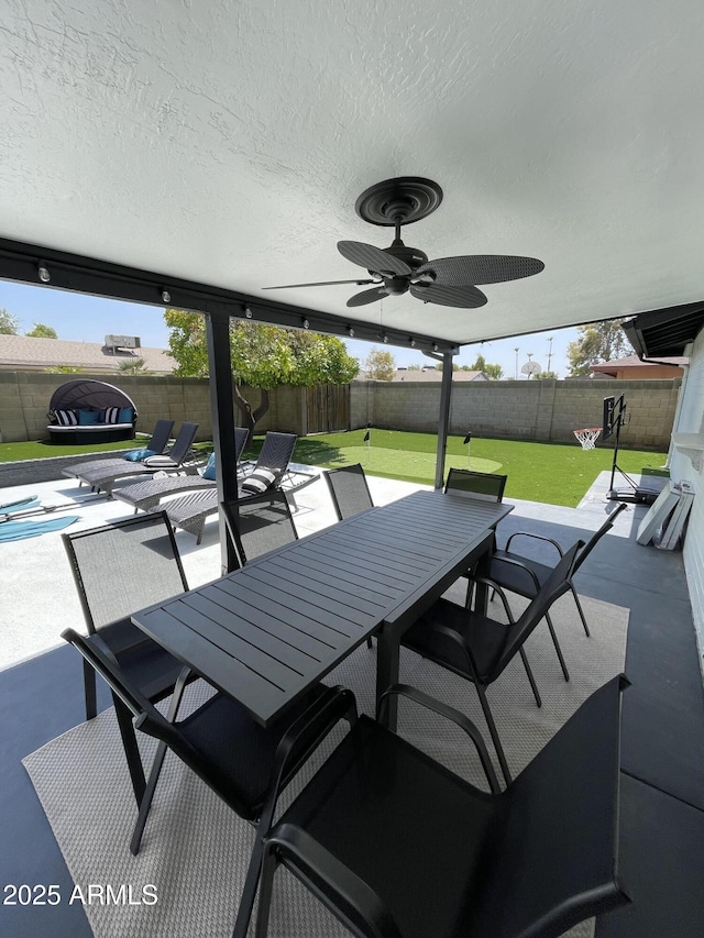 view of patio with outdoor dining space and a ceiling fan