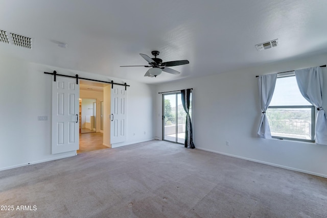 7398 W Paso Trl, Peoria, AZ 85383 - carpeted empty room featuring ceiling fan, a barn door, and a smoke detector