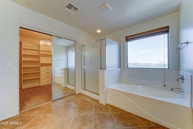 7398 W Paso Trl, Peoria, AZ 85383 - bathroom with a bath, tile patterned flooring, a stall shower, and a walk in closet