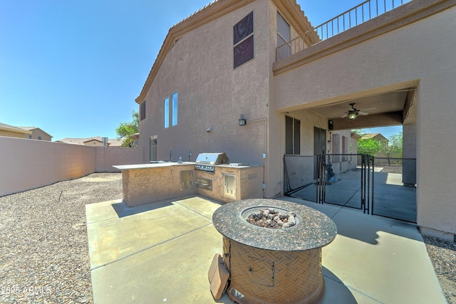 7398 W Paso Trl, Peoria, AZ 85383 - fenced backyard with exterior kitchen, a patio, a gate, and an outdoor fire pit