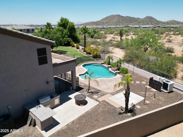 7398 W Paso Trl, Peoria, AZ 85383 - view of pool with a patio, a mountain view, area for grilling, a fenced backyard, and an outdoor fire pit