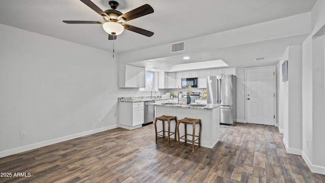 kitchen featuring white cabinetry, dark wood-style flooring, visible vents, and appliances with stainless steel finishes