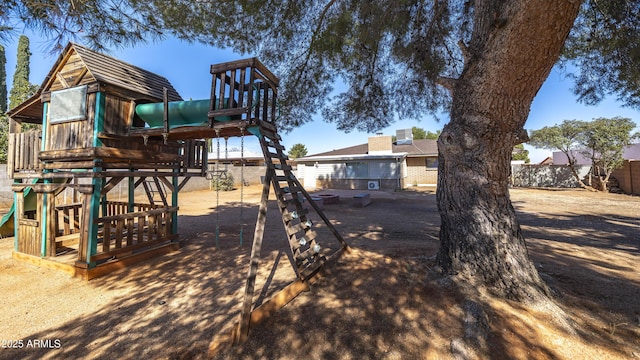 view of jungle gym featuring fence