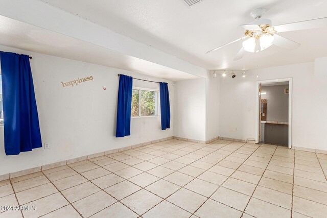 tiled empty room with ceiling fan