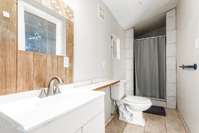 bathroom with vanity, toilet, a shower with shower curtain, and tile patterned floors