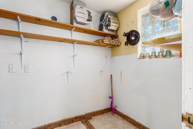 laundry area with light tile patterned floors