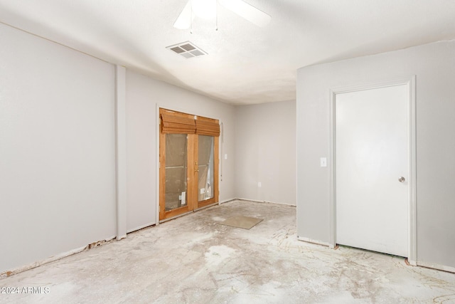 empty room with ceiling fan, concrete floors, and visible vents