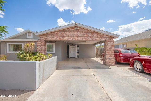 single story home with a carport, concrete driveway, and stucco siding