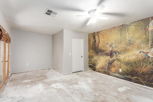 unfurnished room with ceiling fan and visible vents