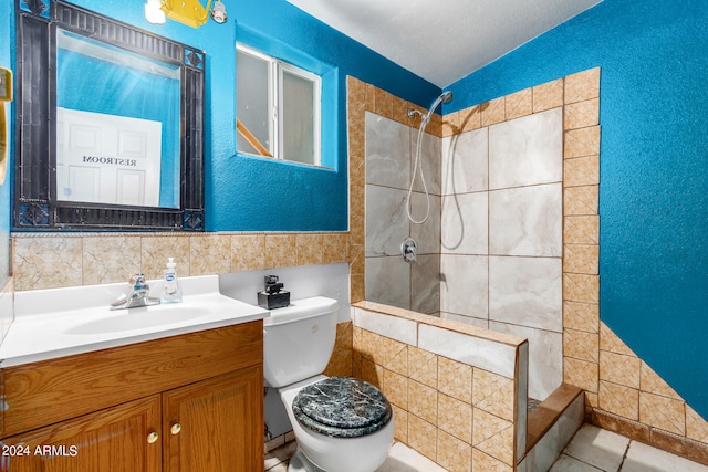 bathroom featuring tile walls, toilet, a tile shower, and tile patterned flooring