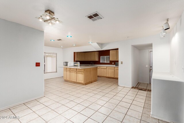 kitchen featuring light brown cabinets and light tile patterned flooring