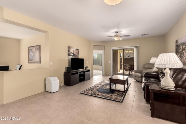 tiled living room featuring ceiling fan