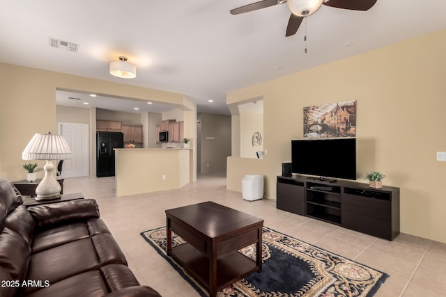 tiled living room with ceiling fan