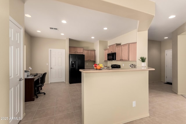 kitchen with kitchen peninsula, light tile patterned floors, and black appliances