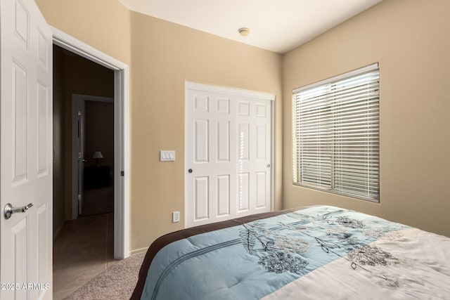 tiled bedroom featuring a closet