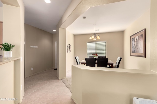 tiled dining area with an inviting chandelier