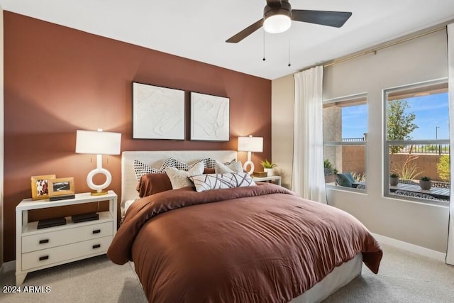 bedroom with ceiling fan and light colored carpet