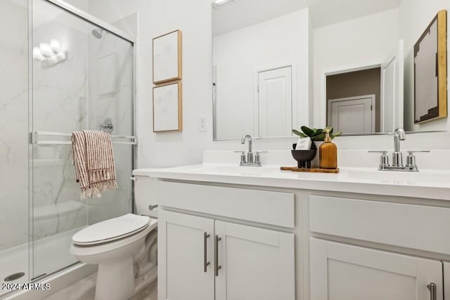 bathroom with vanity, toilet, and an enclosed shower