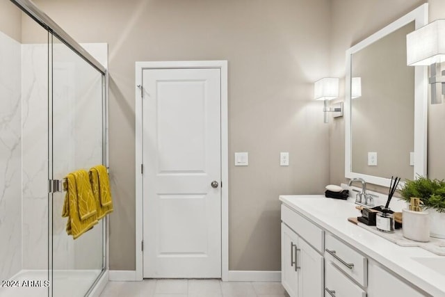 bathroom with tile patterned flooring, vanity, and walk in shower