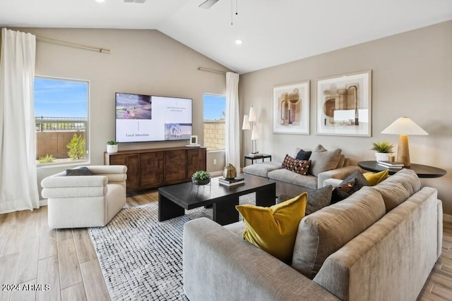 living room featuring light hardwood / wood-style flooring and vaulted ceiling