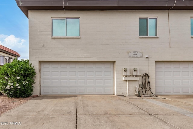 1916 W Morningside Dr Unit 108, Phoenix, AZ 85023 - view of front of property with a garage, concrete driveway, and brick siding