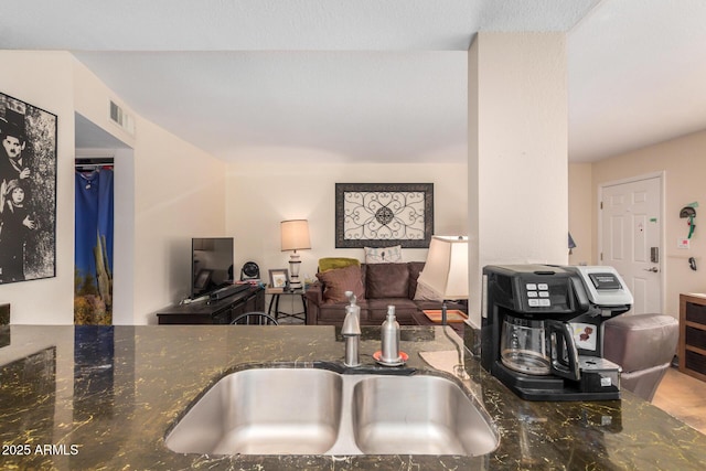 1916 W Morningside Dr Unit 108, Phoenix, AZ 85023 - kitchen featuring dark stone counters and visible vents