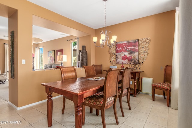 tiled dining area with an inviting chandelier