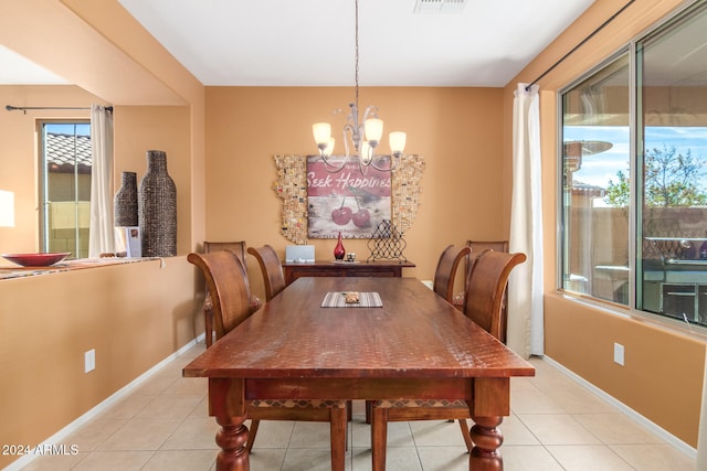 tiled dining area with an inviting chandelier