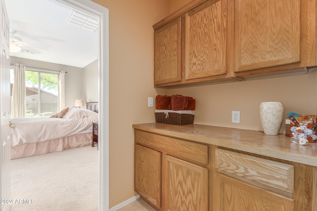 kitchen featuring light colored carpet and ceiling fan