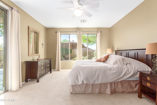 bedroom with ceiling fan and light carpet