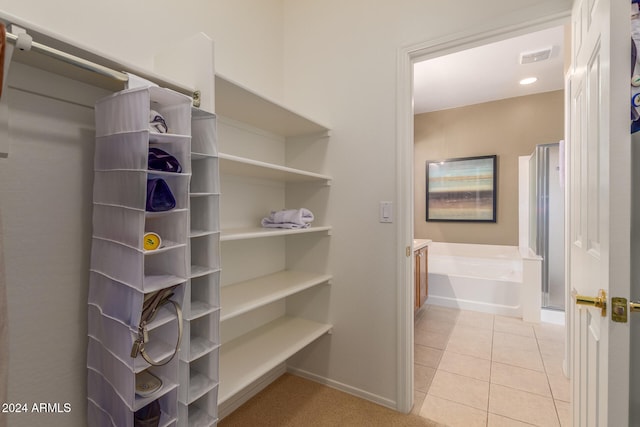 spacious closet with light tile patterned floors