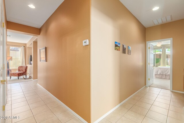 hall with light tile patterned flooring and plenty of natural light