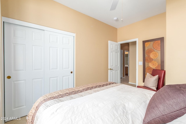 carpeted bedroom with a closet and ceiling fan