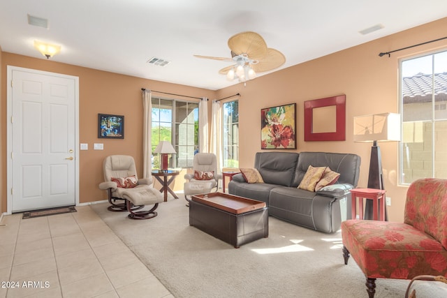 tiled living room with ceiling fan and plenty of natural light