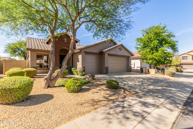 mediterranean / spanish-style home with a garage