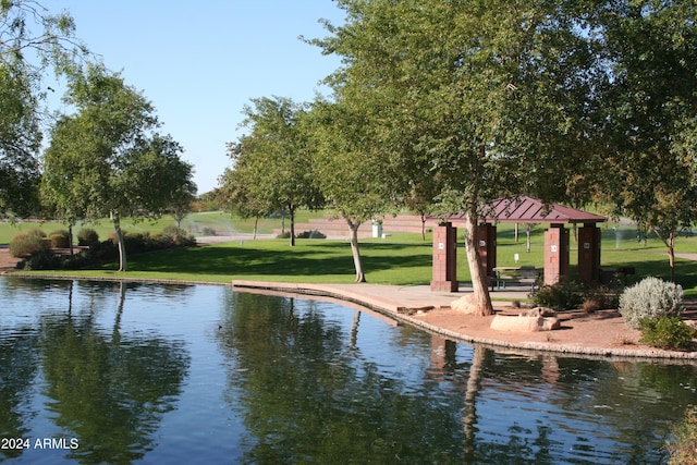 view of home's community with a gazebo, a lawn, and a water view