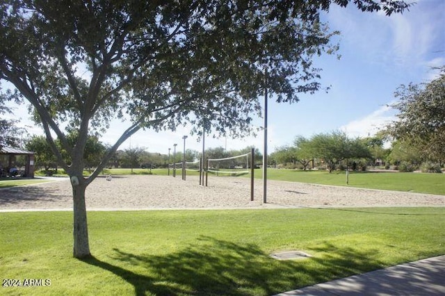 view of home's community with a lawn and volleyball court