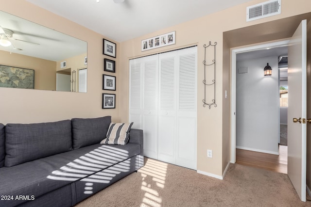 living room featuring carpet floors and ceiling fan