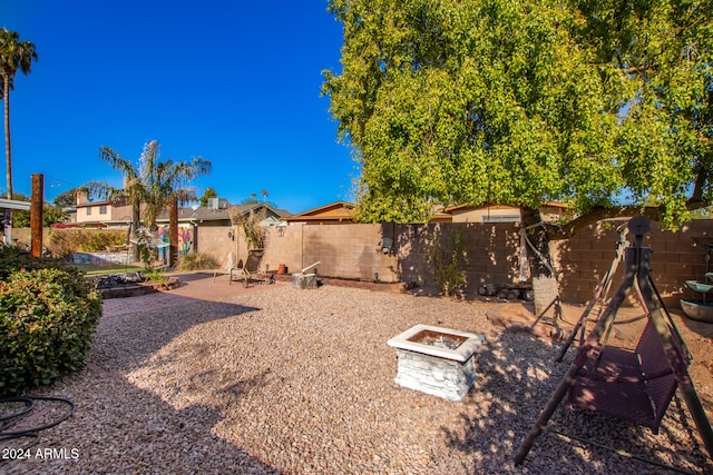 view of yard with a fire pit