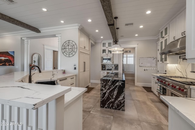 kitchen with light stone counters, pendant lighting, beamed ceiling, white cabinetry, and a large island